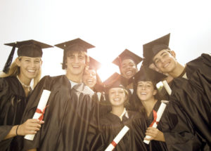 Smiling Graduates with Diplomas